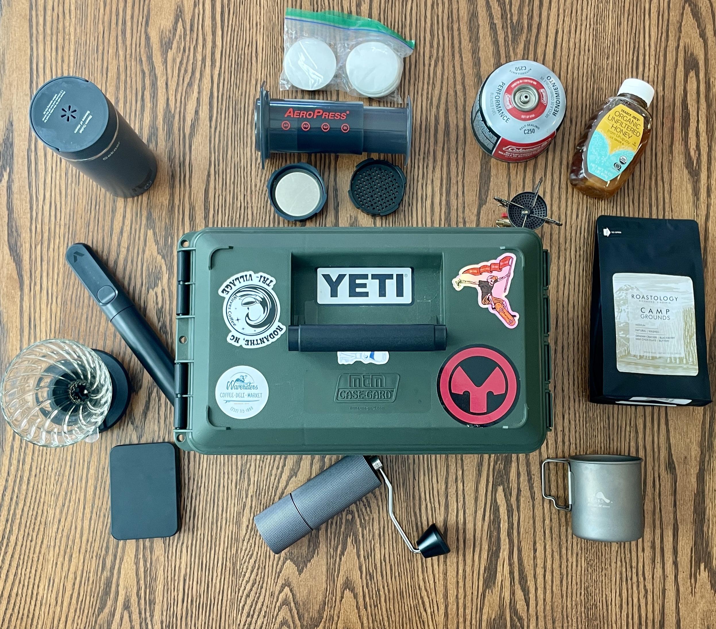 Travel coffee kit laid out next to an olive drab ammo can